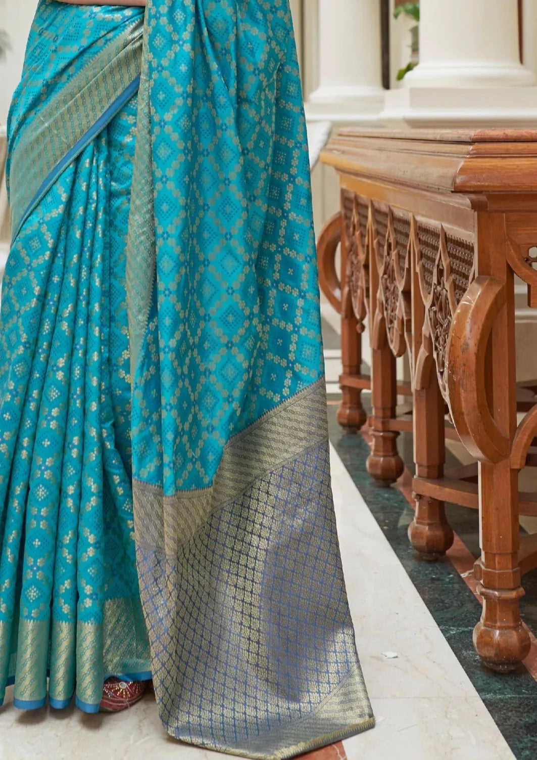 Banarasi silk turquoise blue bandhani saree design.