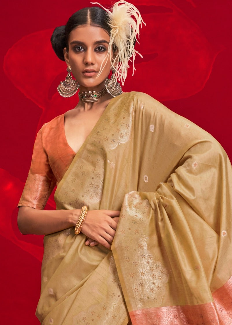 Elegant orange blouse paired with beige tussar silk saree perfect for summer wedding look.