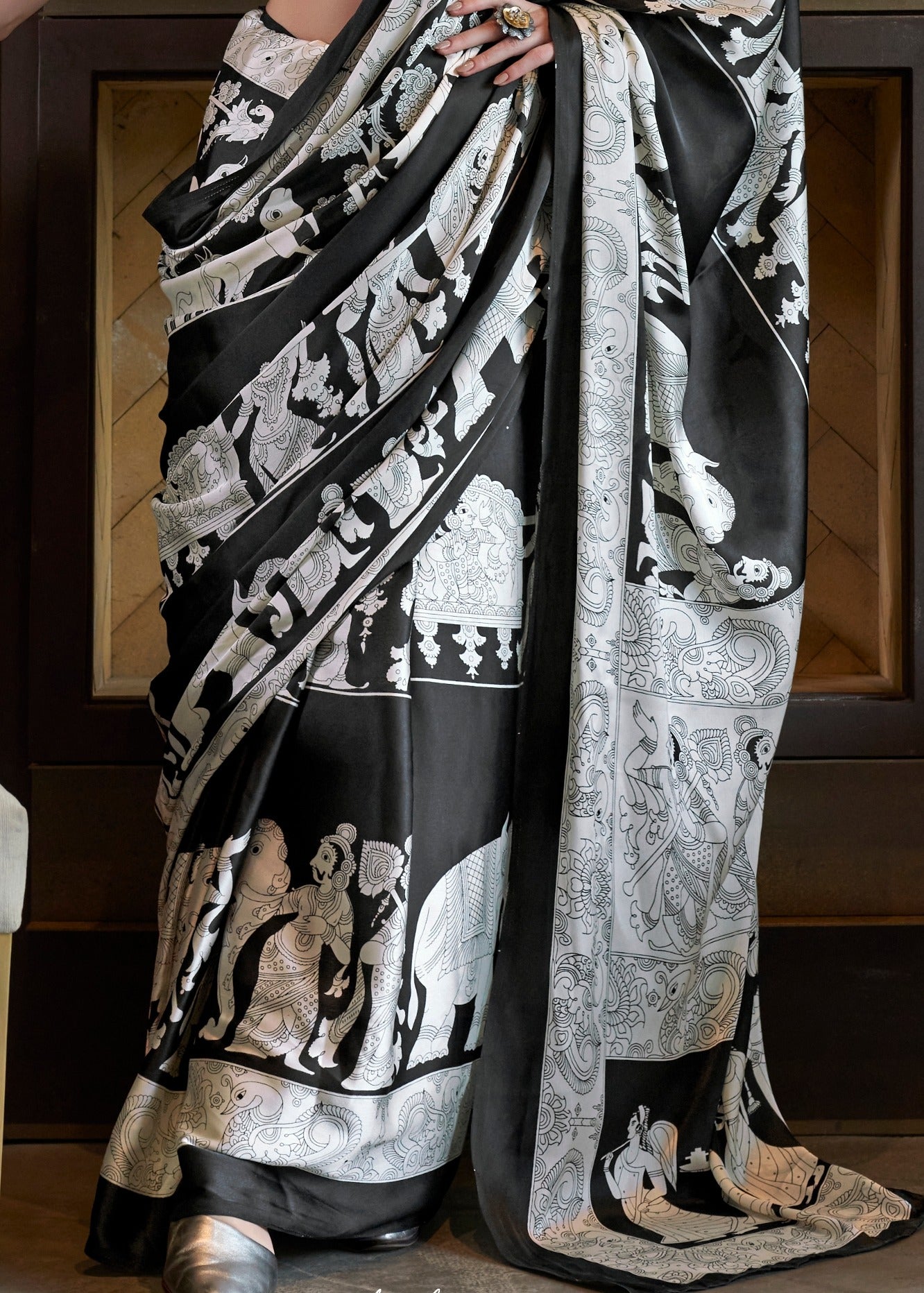 Elegant draping of pure satin crepe black and white kalamkari saree showcasing luxurious flow.