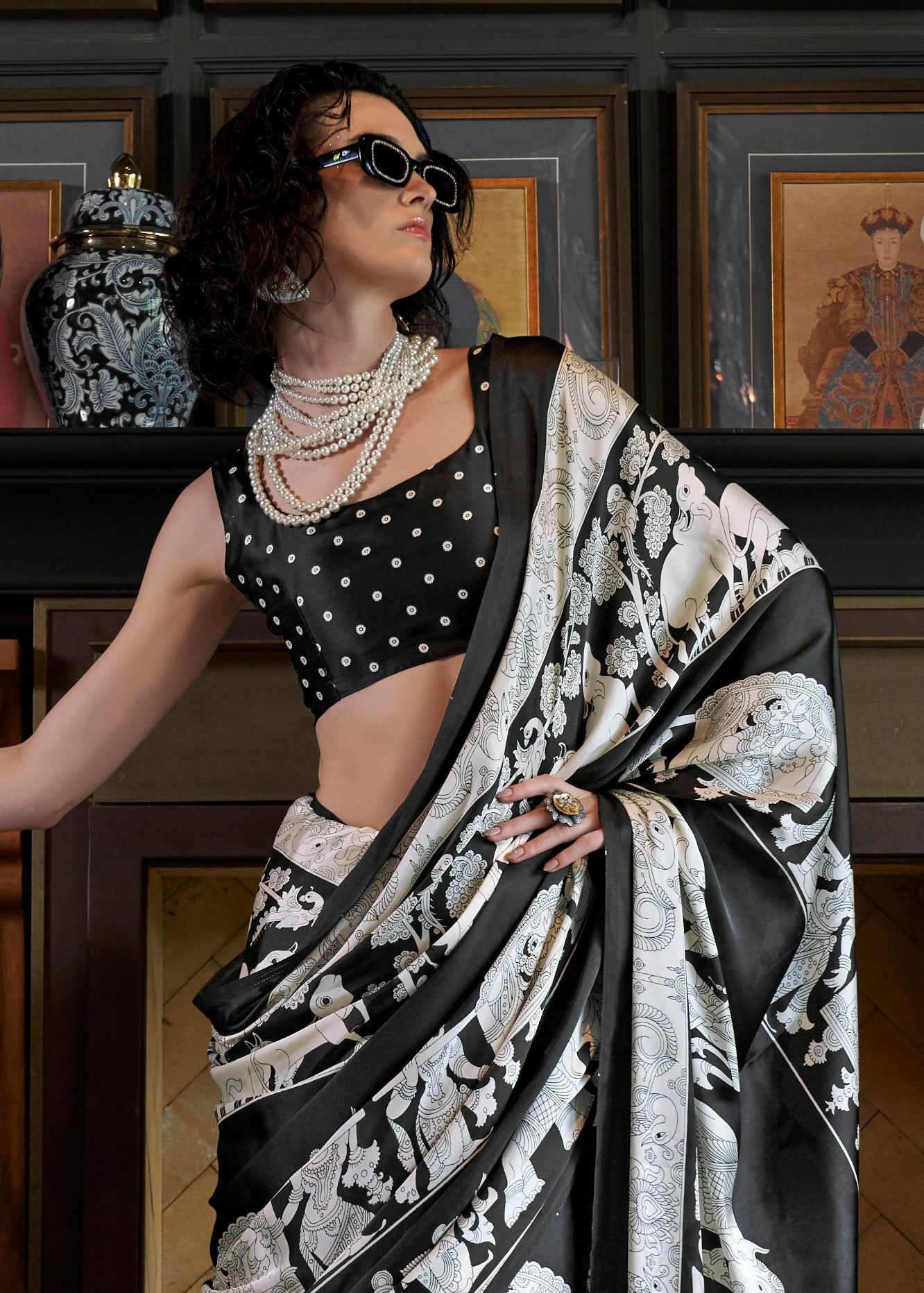 Black blouse paired with pure satin crepe black and white kalamkari saree.