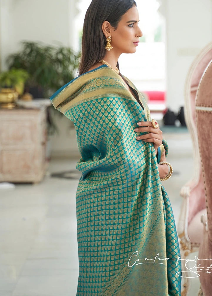 Bride in blue kanjivaram silk saree with gold zari weaving motifs and traditional jewelry.