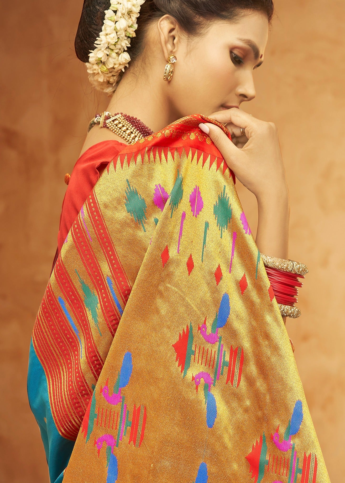 Shop turquoise blue paithani silk saree in india in traditional design online.