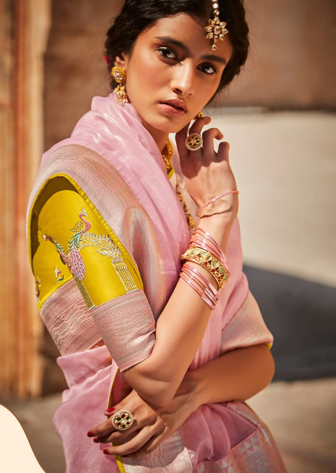 woman in pink organza saree and yellow blouse