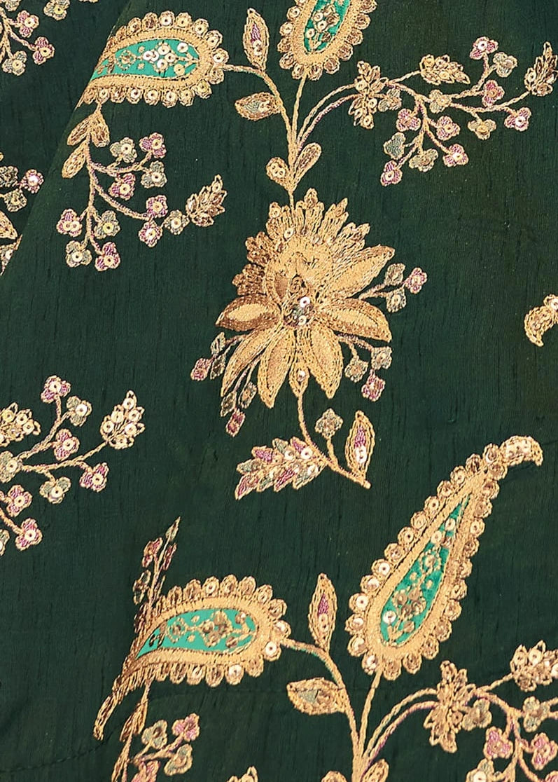Close-up of intricate floral and paisley patterns with sequins on a dark green silk lehenga available in malaysia online to buy.