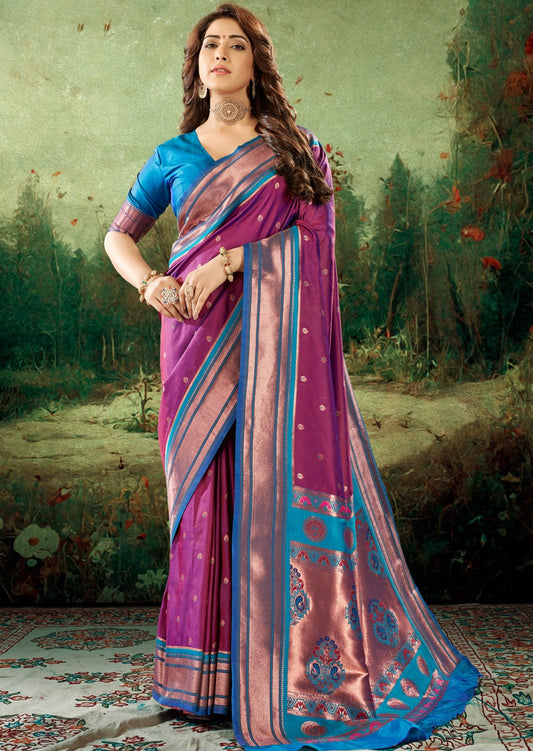 Woman standing in Copper Zari Peshwai Paithani Silk Handloom Saree blouse in Magenta pink colour. Paithani saree has contrast blouse in blue colour.