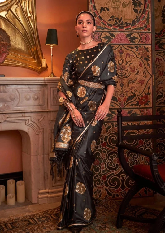 woman standing bWoman in copper zari weaving pure satin silk black saree blouse.