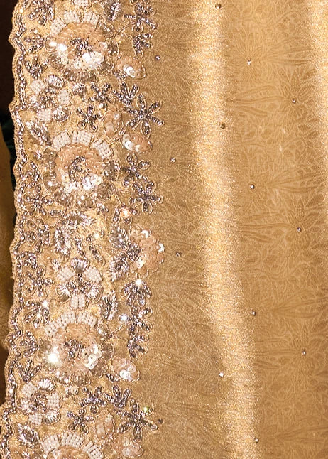 Macro close-up showing the texture of pure ivory cream Kanchipuram silk saree intricately hand-embellished with micro-sequins and delicate glass beadwork catching the light.