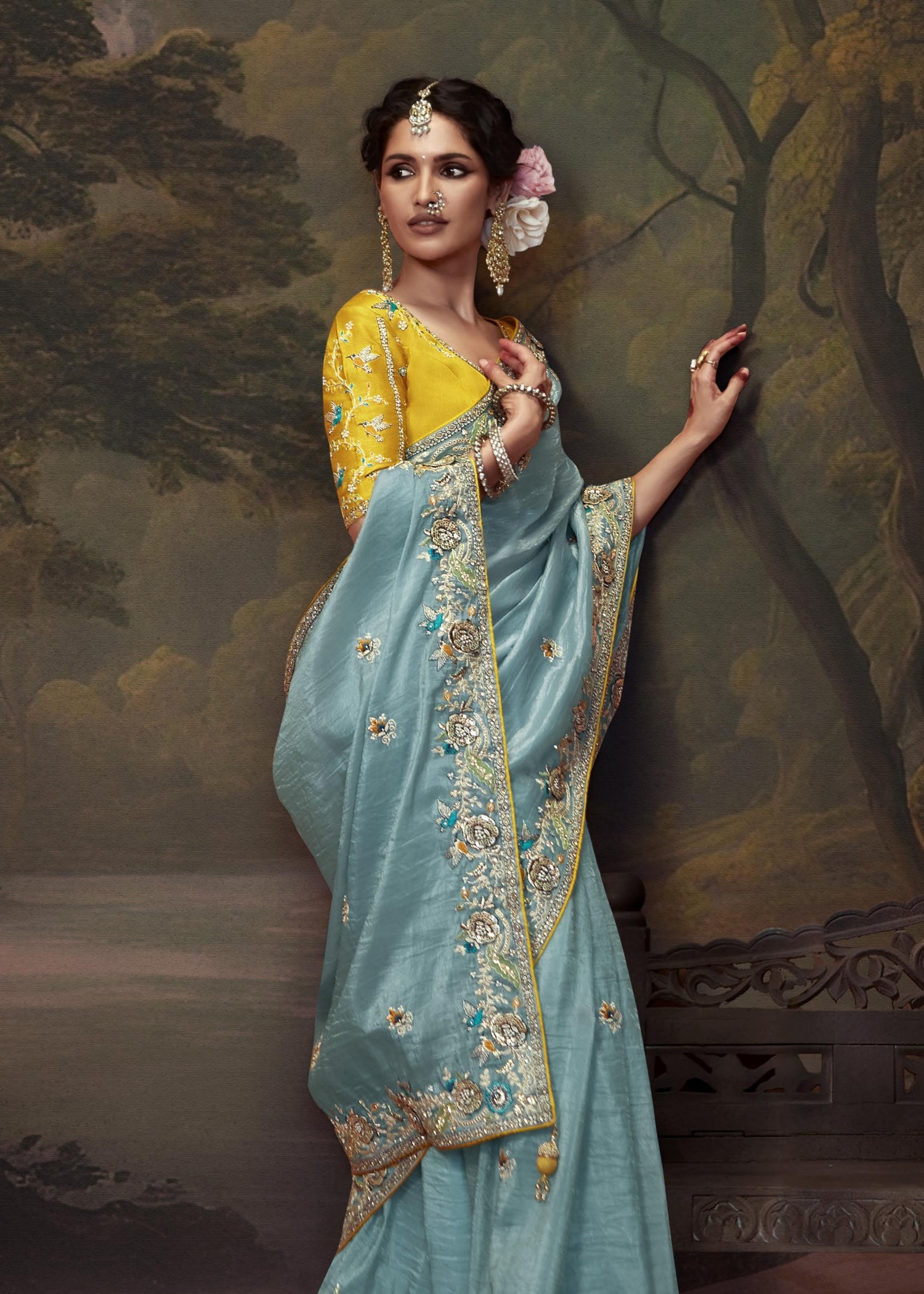 Crushed silk tissue sarees online with hand work embroidery in pastel blue colour with yellow blouse.