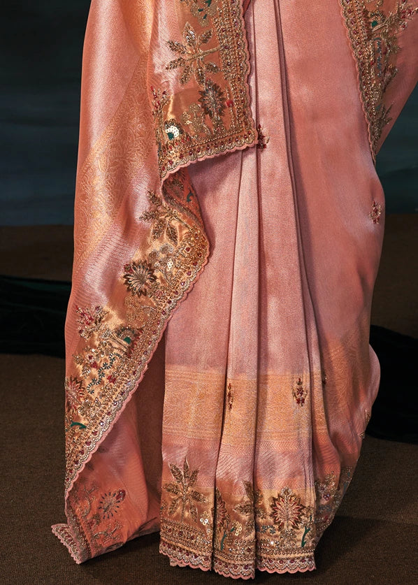 Heavy hand-woven gold zari woven pink kanjivaram saree pleats adorned with layered dabka patterns, mirror work and handcrafted beadwork.