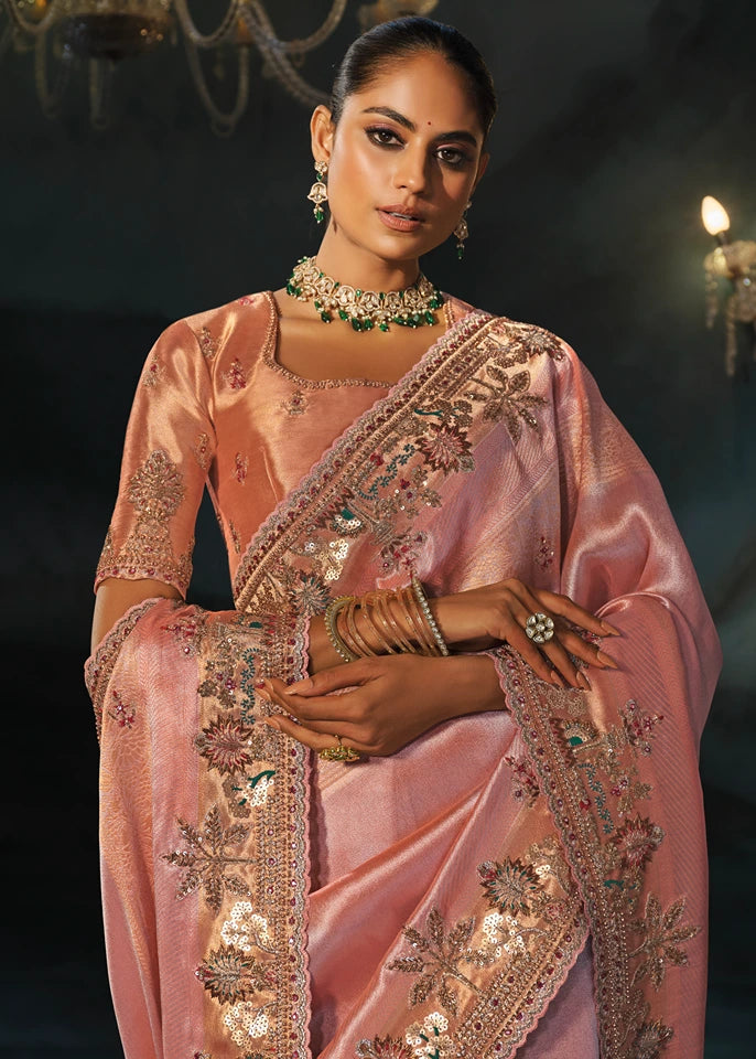 Detailed close-up of handcrafted dabka, sparkling sequins, and reflective mirror work on the heavy pallu of a blush pink silk saree.