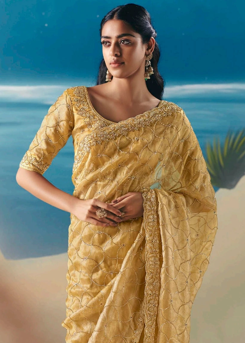 Close up of designer pastel yellow organza tissue bridal saree blouse online with sequins and beadwork hand embroidery for teej, sangeet and cocktail party.