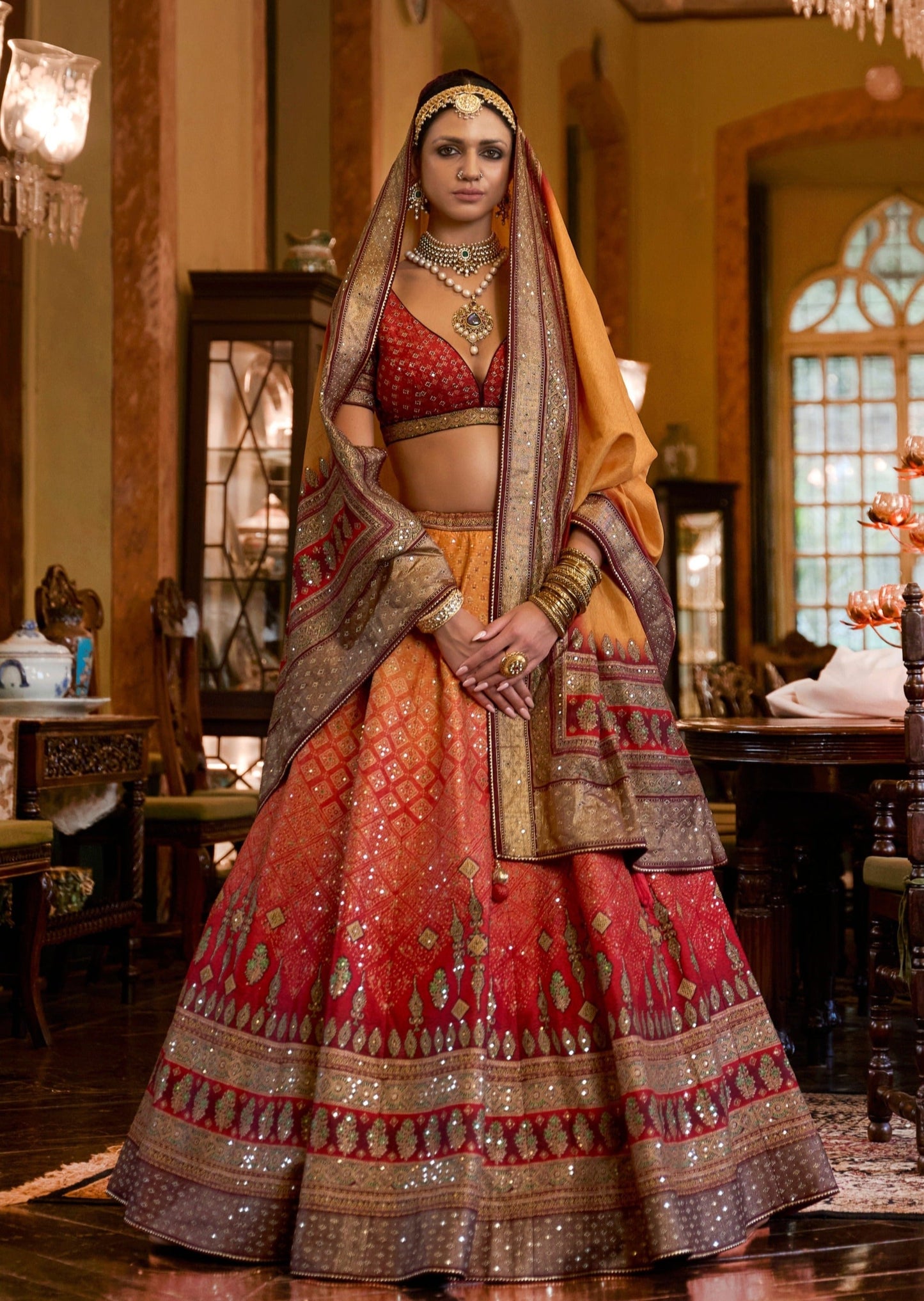 Bride in designer pure silk zari bridal lehenga choli in red yellow color.