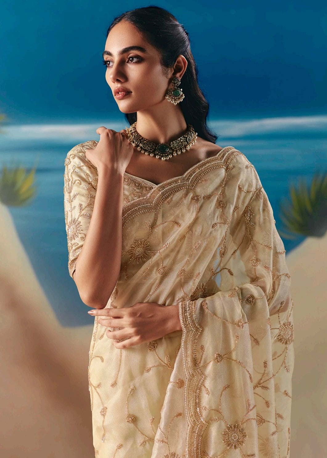Elegant cream tissue silk bridal saree with hand embroidered beadwork and sequins for reception, engagement and wedding guest look.