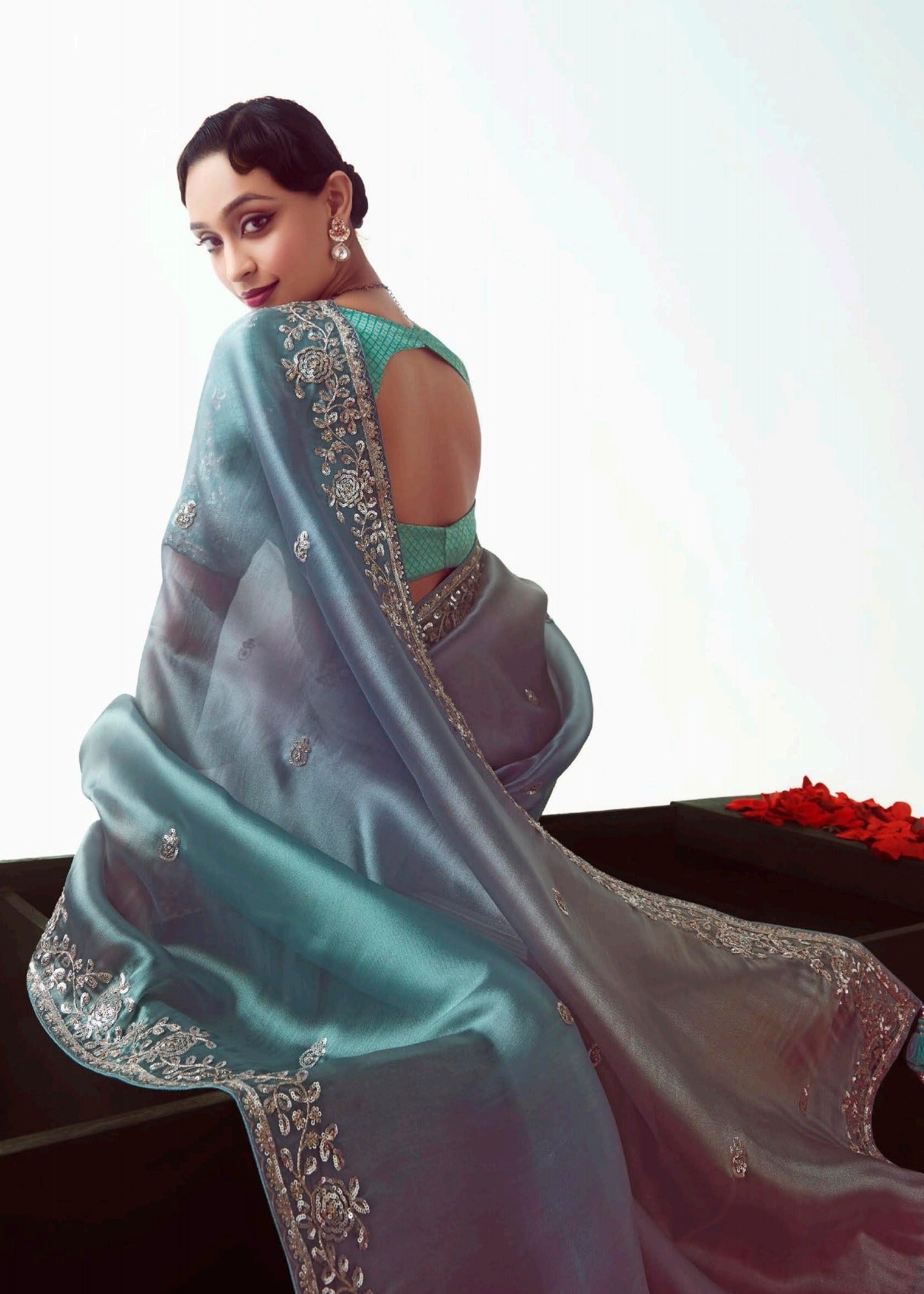 Embroidered organza tissue silk saree in blue shades for festive occasions made with lightweight organza tissue silk paired with banarasi blouse piece.