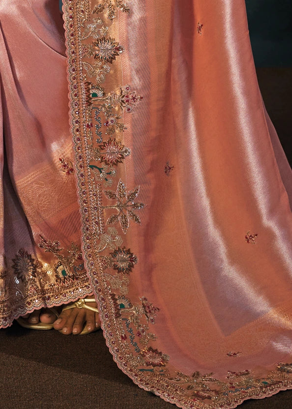 Intricate floral layout on a pastel pink Kanjivaram saree pallu combining shiny mirror work, delicate thread embroidery, beadwork and fine zari borders.