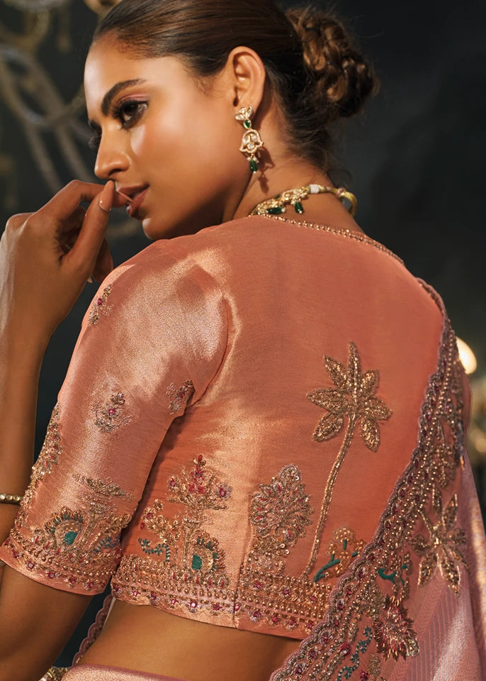 Matching pastel pink kanjivaram silk blouse featuring coordinating hand-embroidered dabka and mirror work borders for sleeves and neckline.