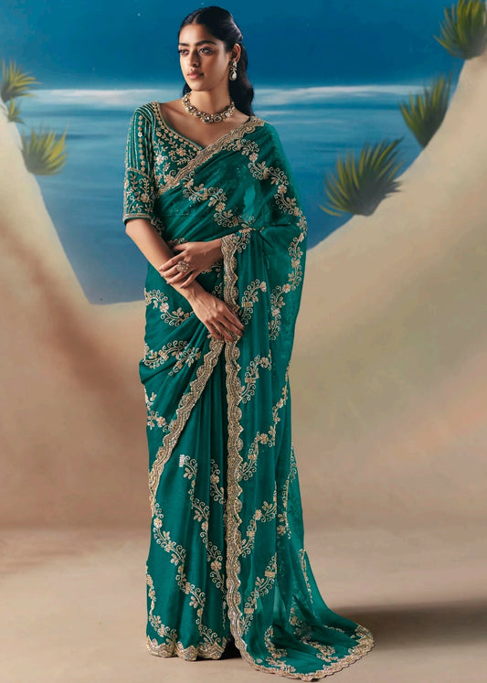 Emerald green organza tissue silk hand embroidered bridal saree with zari work for modern bride.