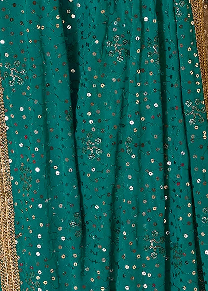 A close-up of a turquoise blue georgette dupatta with scattered metallic silver sequins and a gold embroidered border visible along the edge.