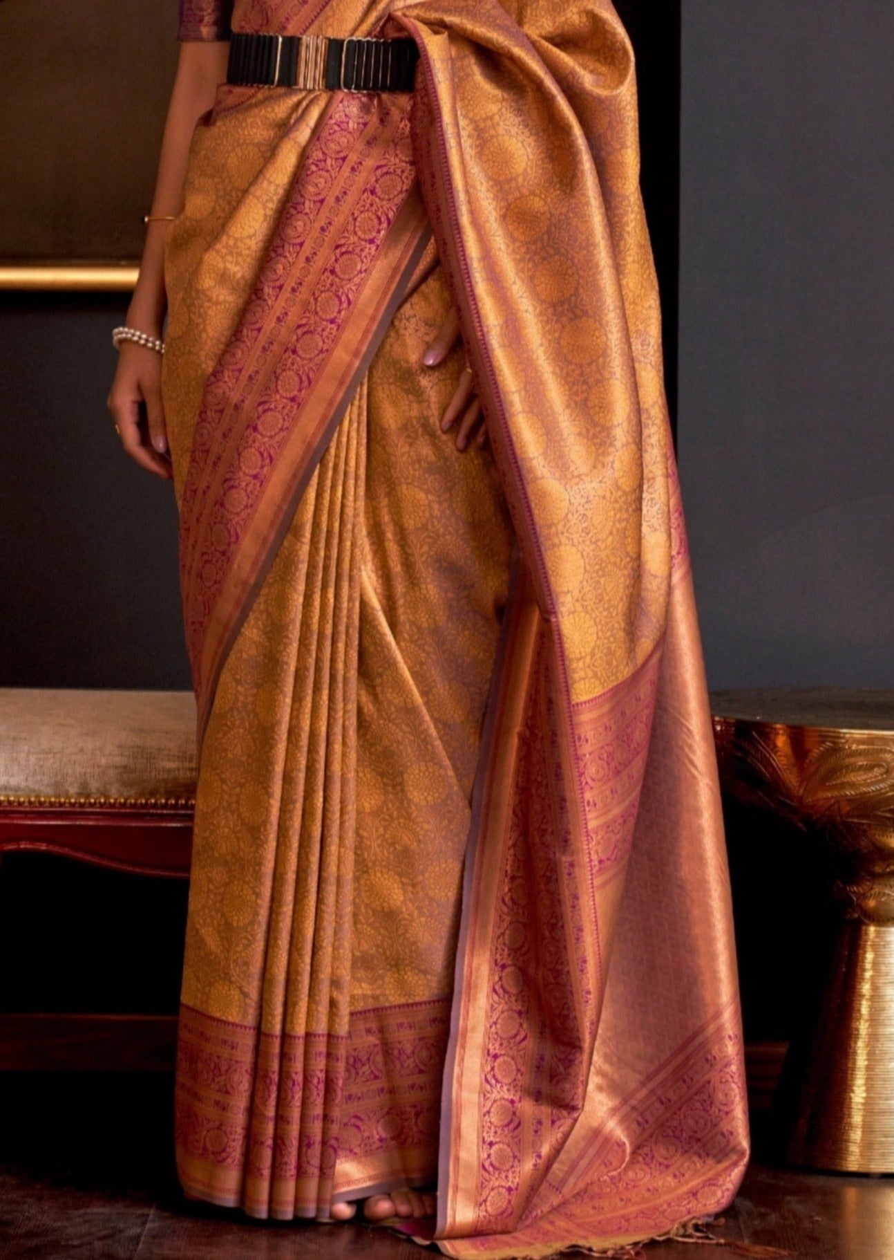 Golden kanjivaram silk saree with contrast purple blouse.