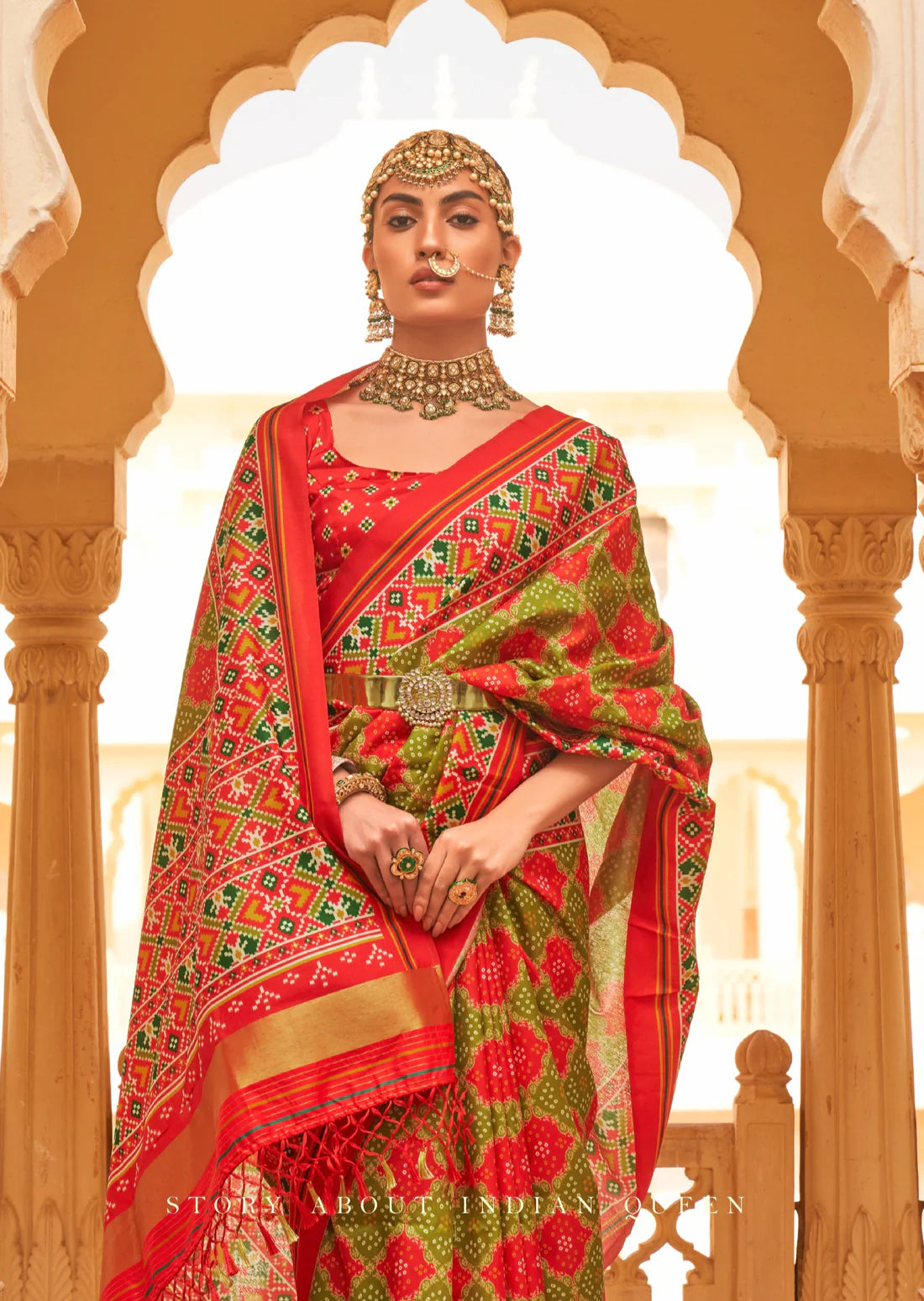 Bride in green and red patola silk saree.