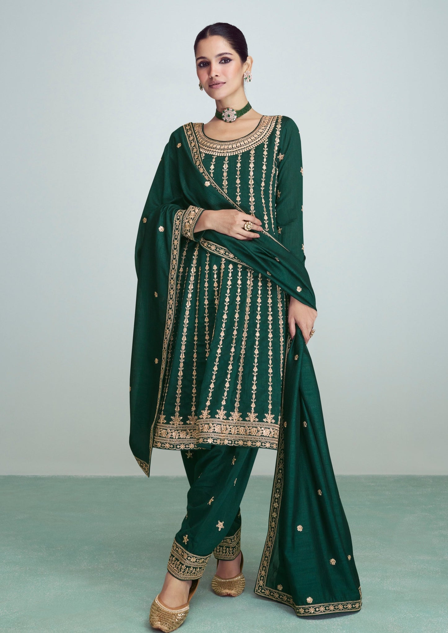 woman in green salwar suit with heavy neck design