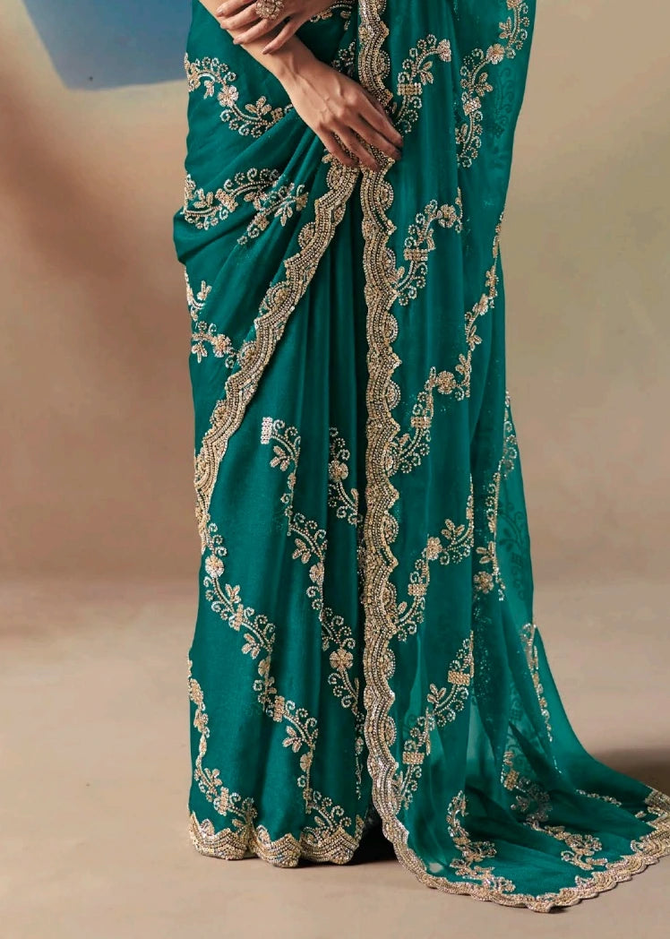 Emerald green saree design with gold embroidery all over featuring a heavy embroidered sequins work pallu.