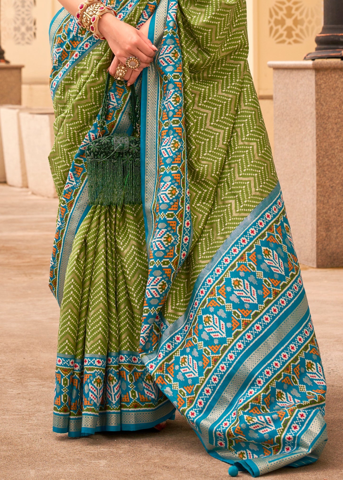 Green patola silk saree online shopping design for wedding function look.