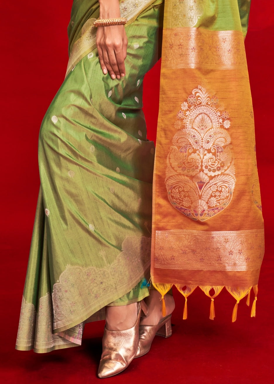 Pure handloom tussar silk green saree with a stylish orange pallu, highlighting rich texture and zari work design.