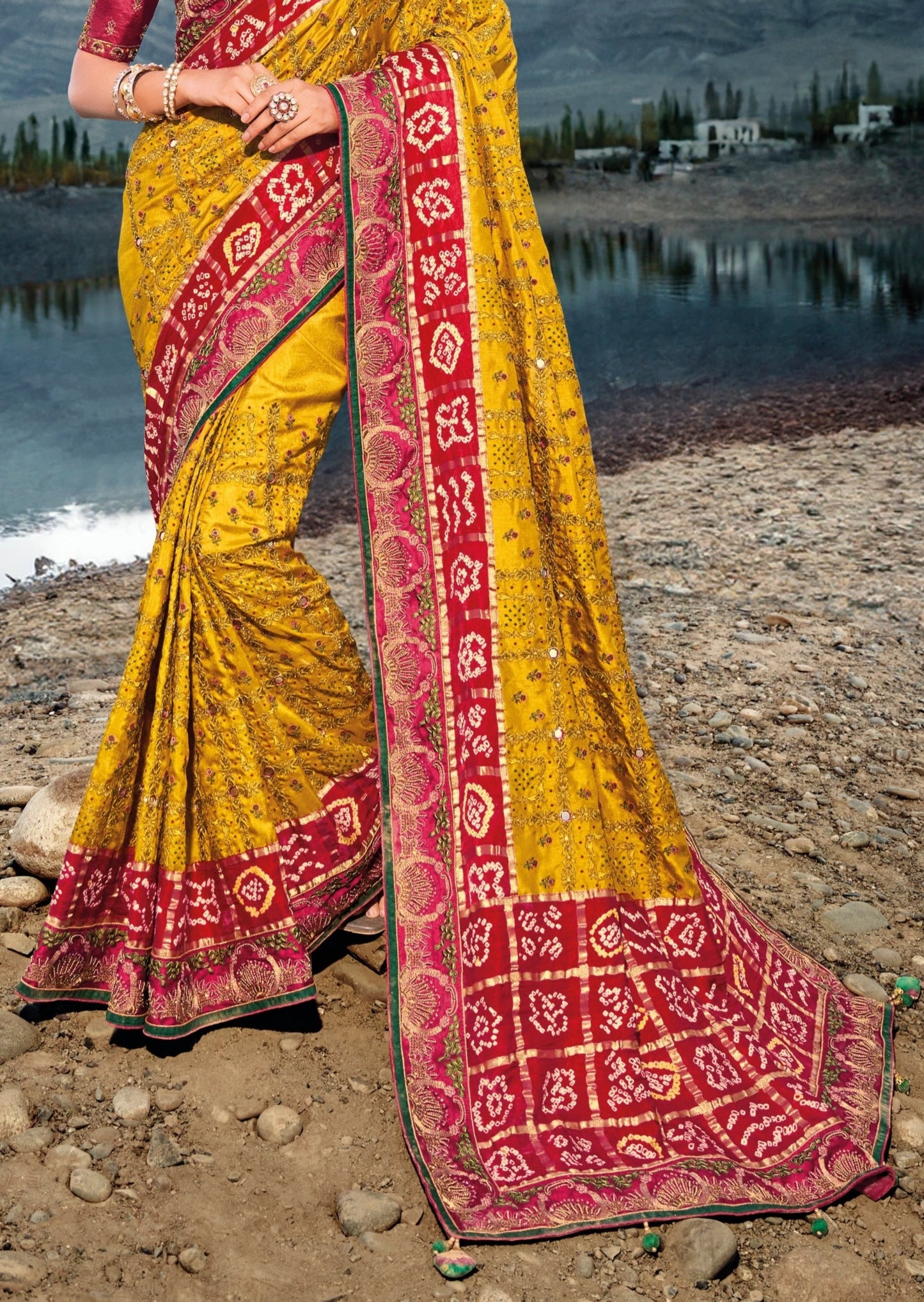Hand embroidery kutch mirror work banarasi silk bandhej bridal saree online in yellow color.