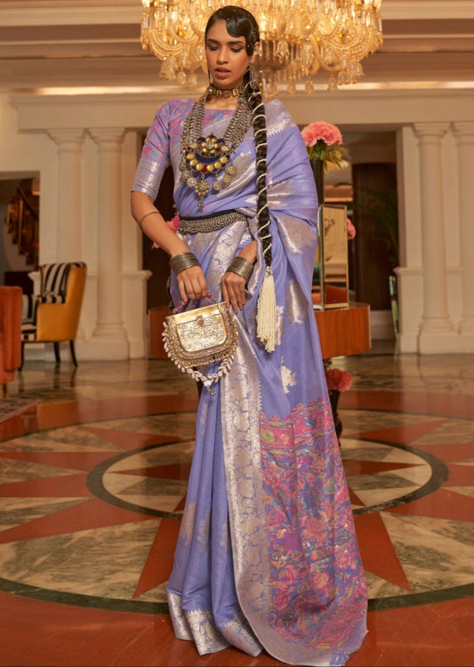 Woman standing in handloom kashmiri banarasi silk lavender purple saree blouse with gold zari weaving border and booti motifs.