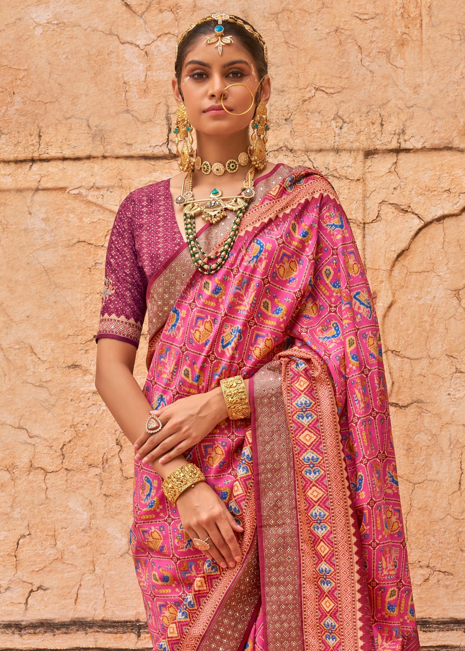 Traditional hathi popat design patola silk saree online in pink color for wedding look.