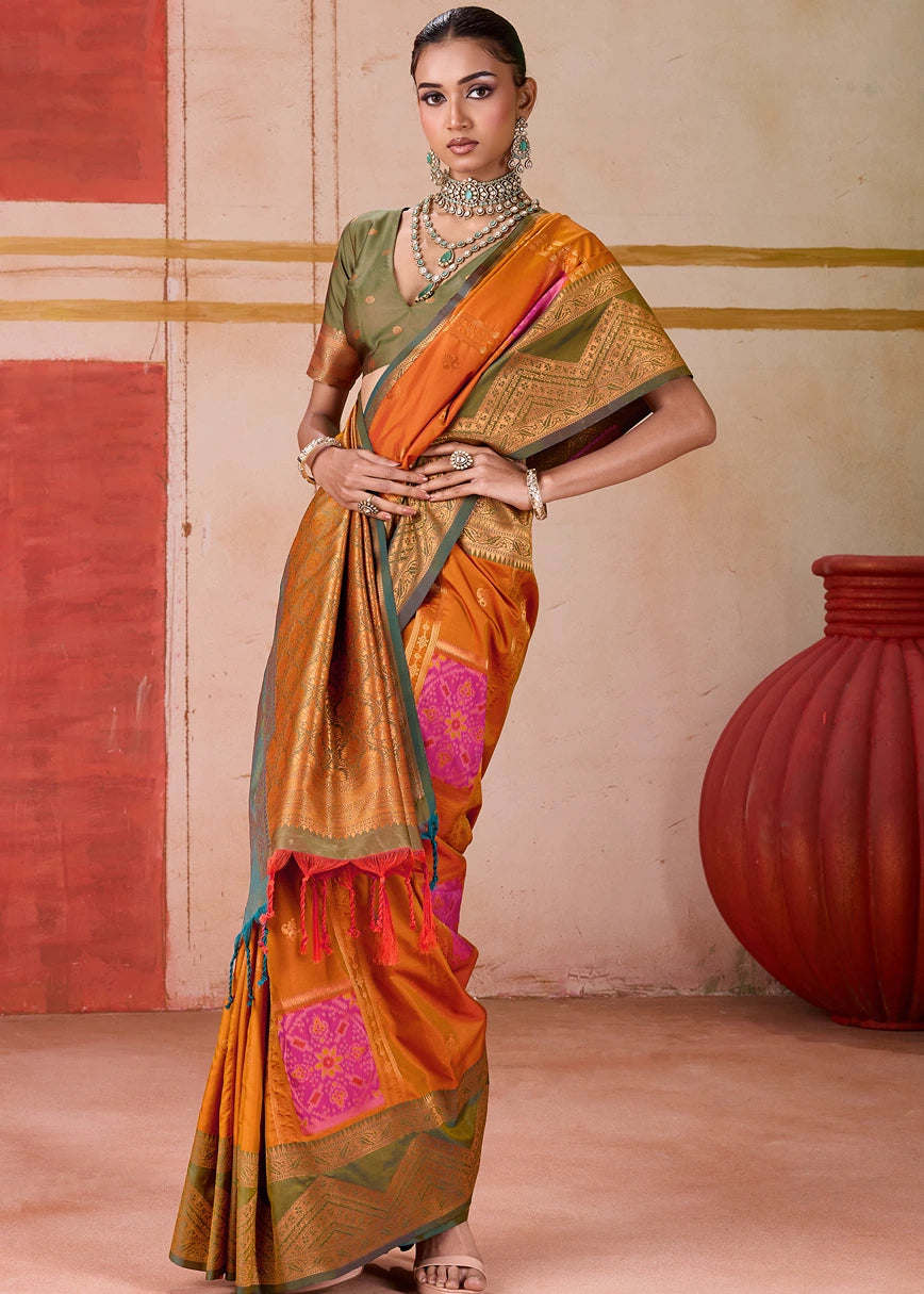 Handwoven Pochampally Patola Silk Saree in orange with intricate Mehendi Green Ikkat border and matching blouse, a masterpiece of traditional Indian textile artistry, ideal for weddings and festive celebrations.