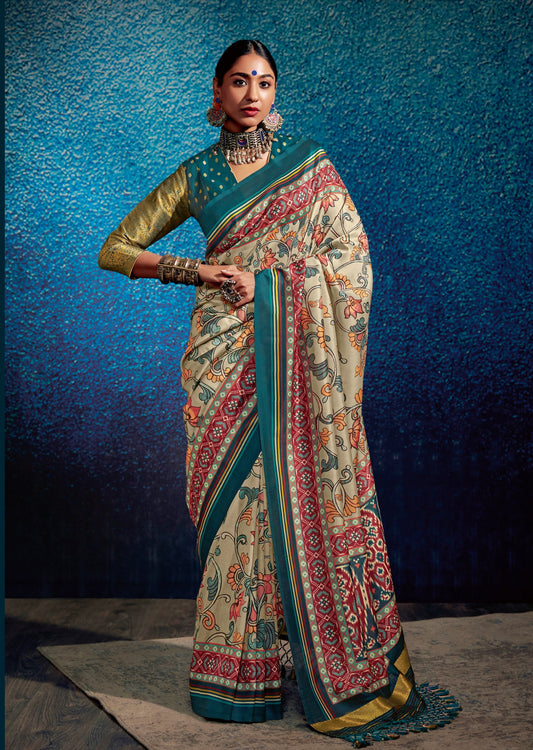 Woman posing in kalamkari patola fusion grey saree in front of blue wall