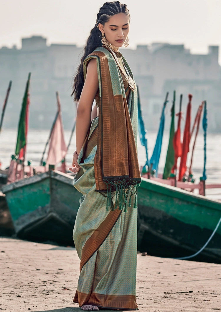 Full length shot of kanjivaram silk green saree with copper zari weaving, contrast black blouse and border.