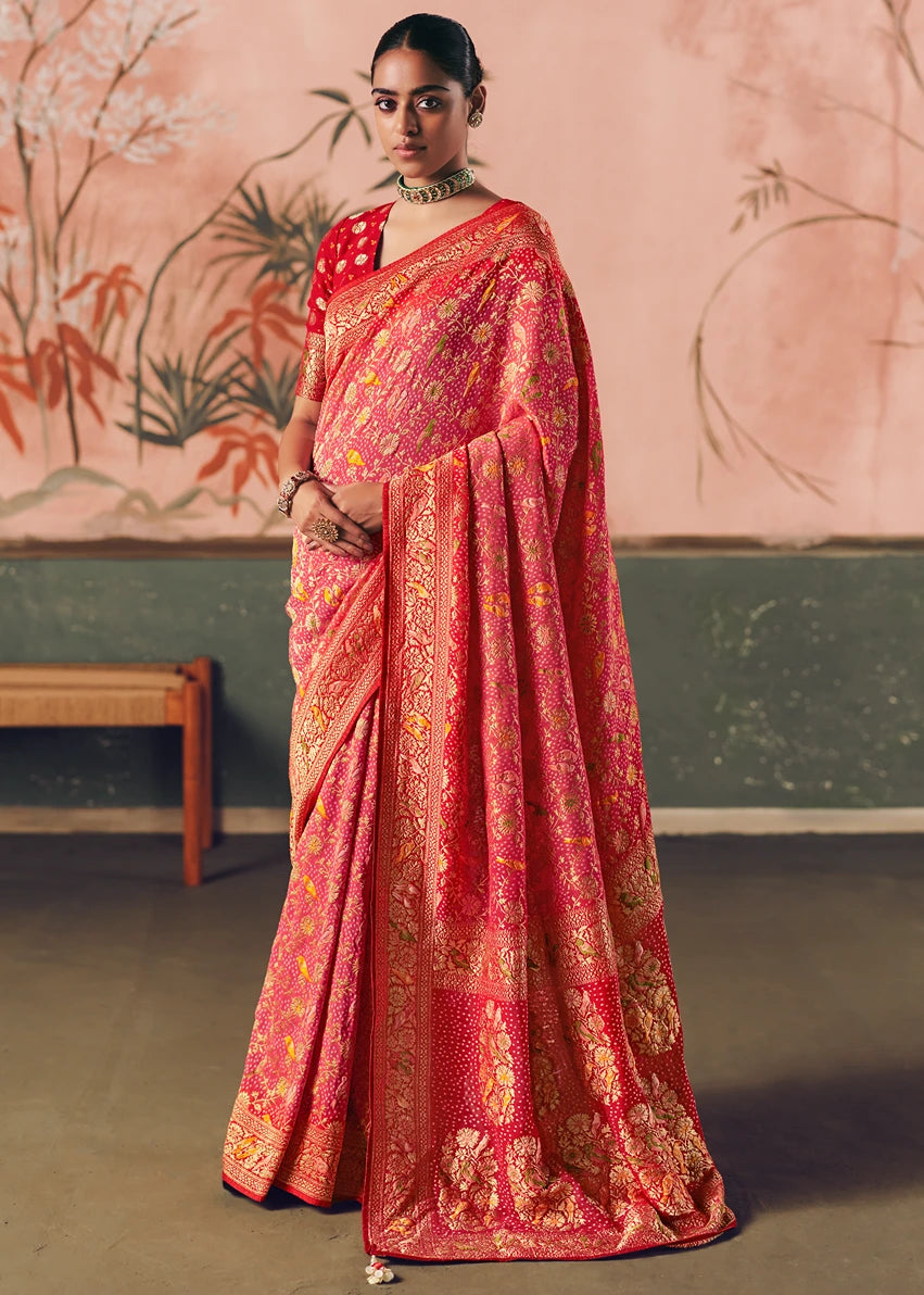 Woman wearing a traditional pastel pink bandhani saree made in pure khaddi banarasi georgette, featuring meenakari floral, birds and animal motifs. 