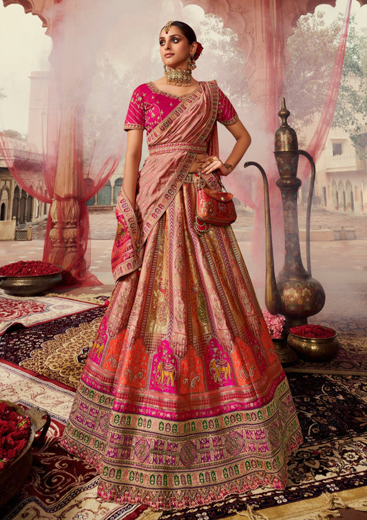 Bride posing in pink banarasi silk lehenga choli with dupatta and indian jewelery.
