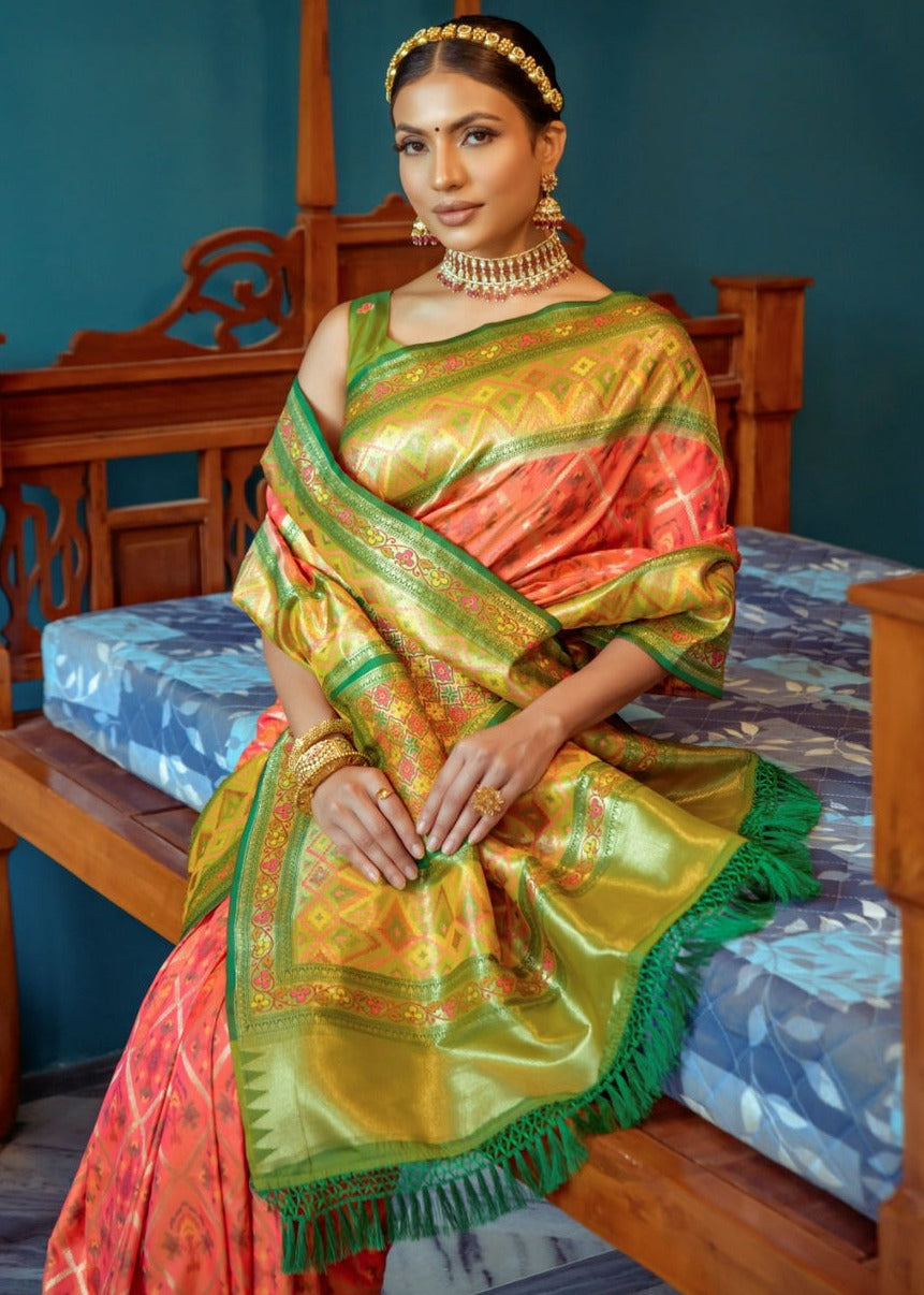 Luxurious orange patola silk saree with traditional design and exquisite craftsmanship.