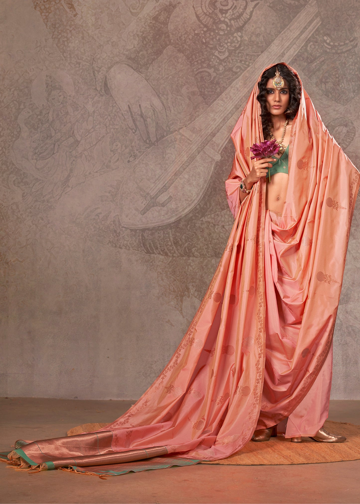 Luxurious peach handloom banarasi silk saree paired with a vibrant green blouse, perfect for festive occasions.