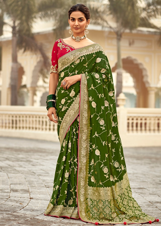 Luxury handloom silk saree in green colour with contrast red blouse featuring heavy embroidery work.