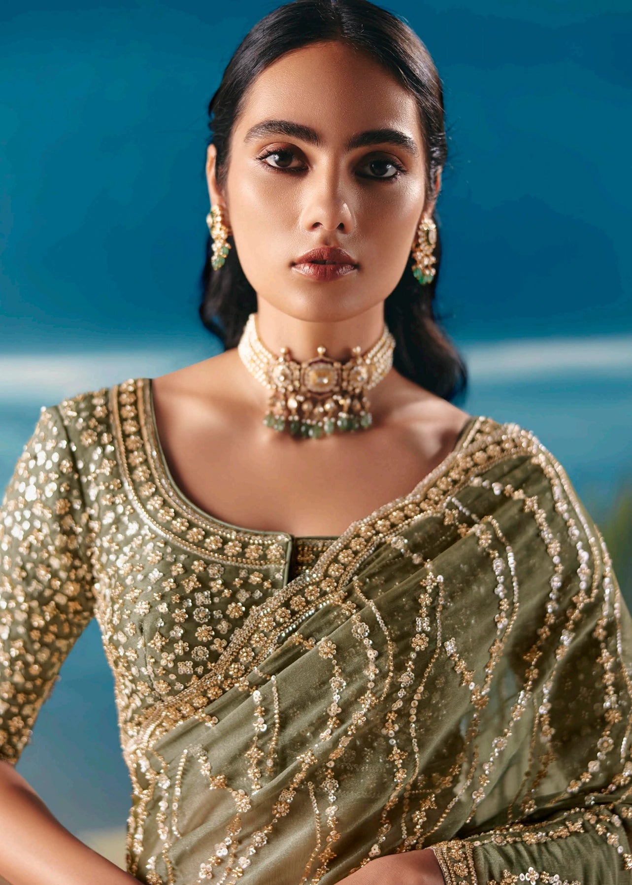 Lightweight olive green hand embroidered organza tissue silk wedding saree with beadwork and sequins for modern indian bride.