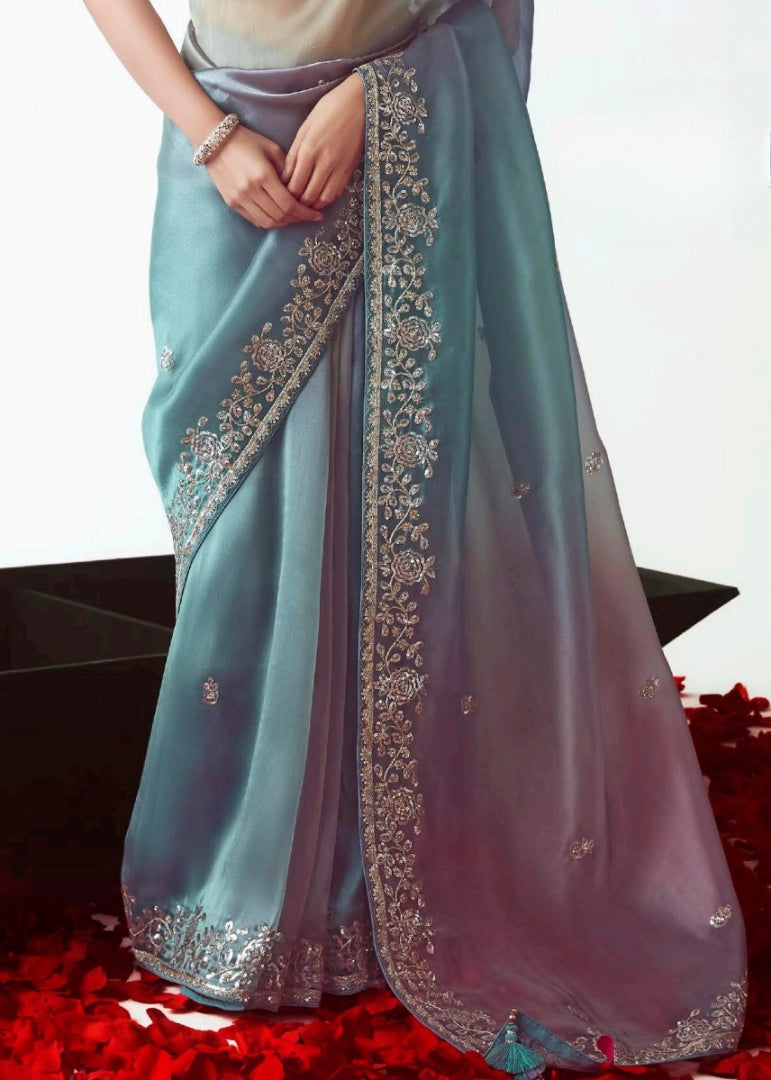 Multicolor blue organza tissue silk embroidered saree with floral motifs and matching blue banarasi blouse for wedding and festive wear.