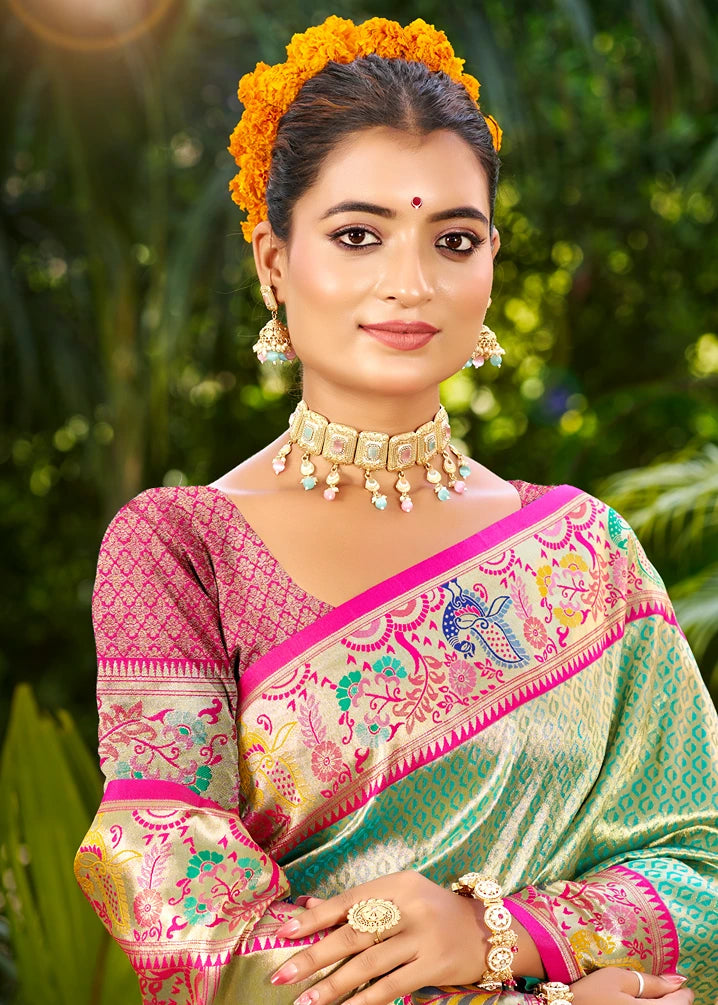 Close up of Ocean Green Paithani silk saree detail featuring tapestry woven peacock motifs in tested gold zari, blue and pink resham meena work on feathers, traditional Yeola handloom technique, rudraksha and narali border pattern, luxury silk texture, bridal festive ethnic wear for women; available online in USA.