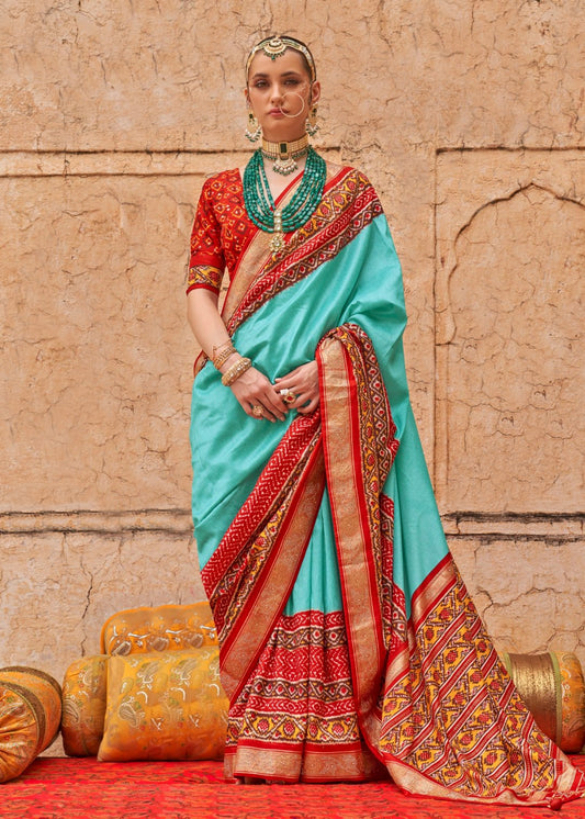 Ocean green patola silk saree with contrast red blouse online shopping in india usa for wedding.