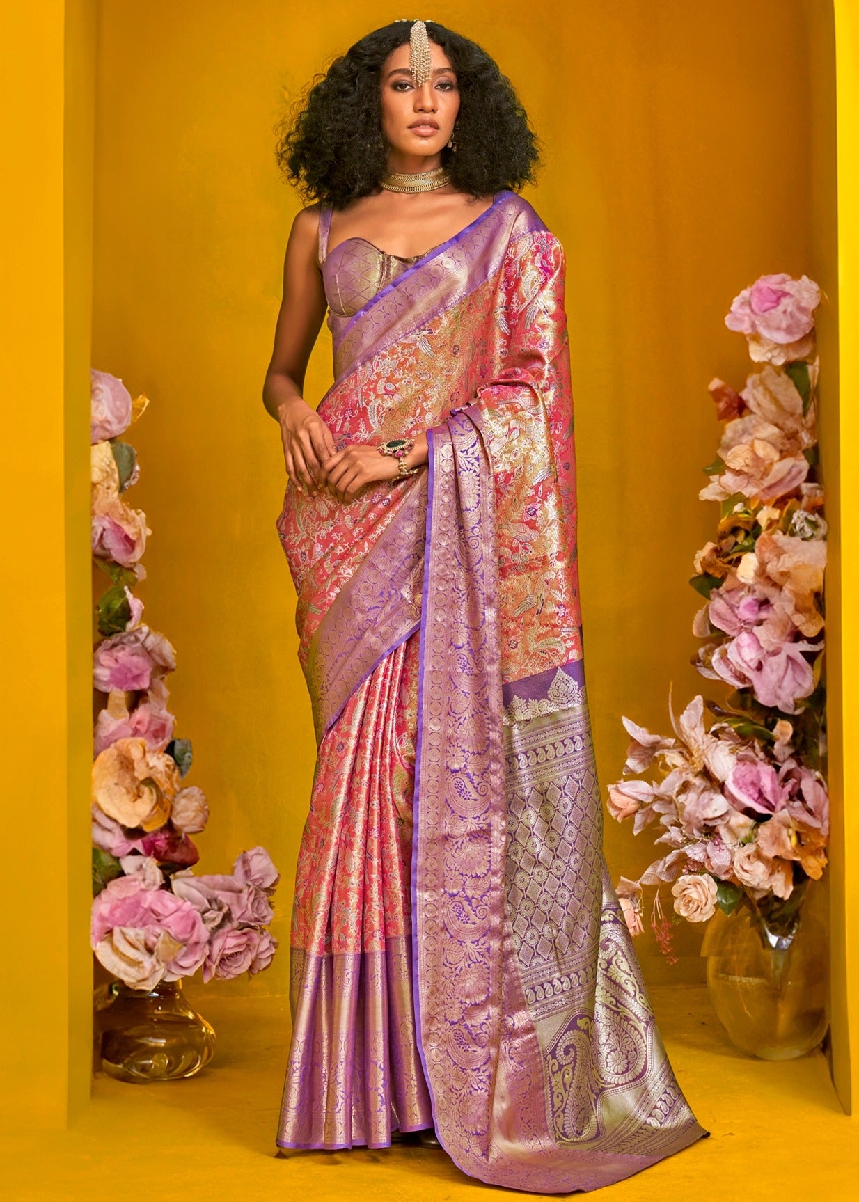 Orange and purple kanjivaram silk handloom saree online with contrast purple blouse made in luxury design.