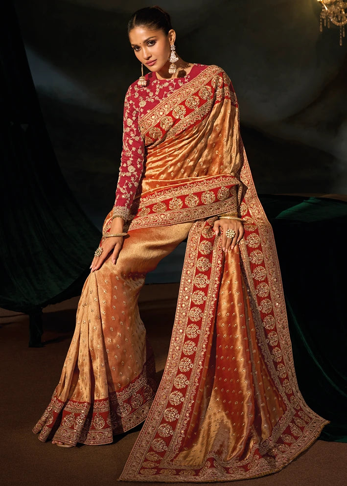 Front view of a bride showcasing the heavy, intricately woven rust orange kanjivaram silk saree pallu with traditional gold zari motifs on red border and subtle sequin shimmer.