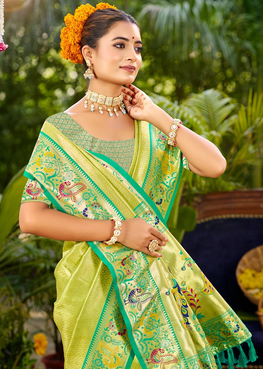 Woman in a parrot green saree in norway with contrast emerald green blouse with floral decorations against a blurred natural background.