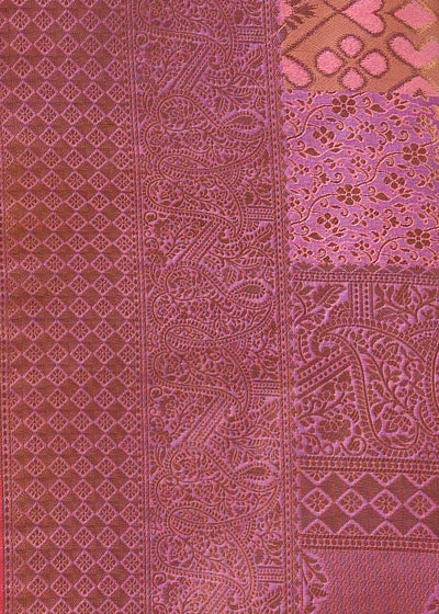 Close-up of a woven pastel pink kanchipuram saree with vertical bands of intricate paisley, patola ikkat and floral patterns.