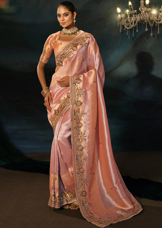 Full drape of a luxury pastel pink Kanjivaram silk saree featuring heavy hand embroidery, mirror work, dabka work and an intricate gold zari border.