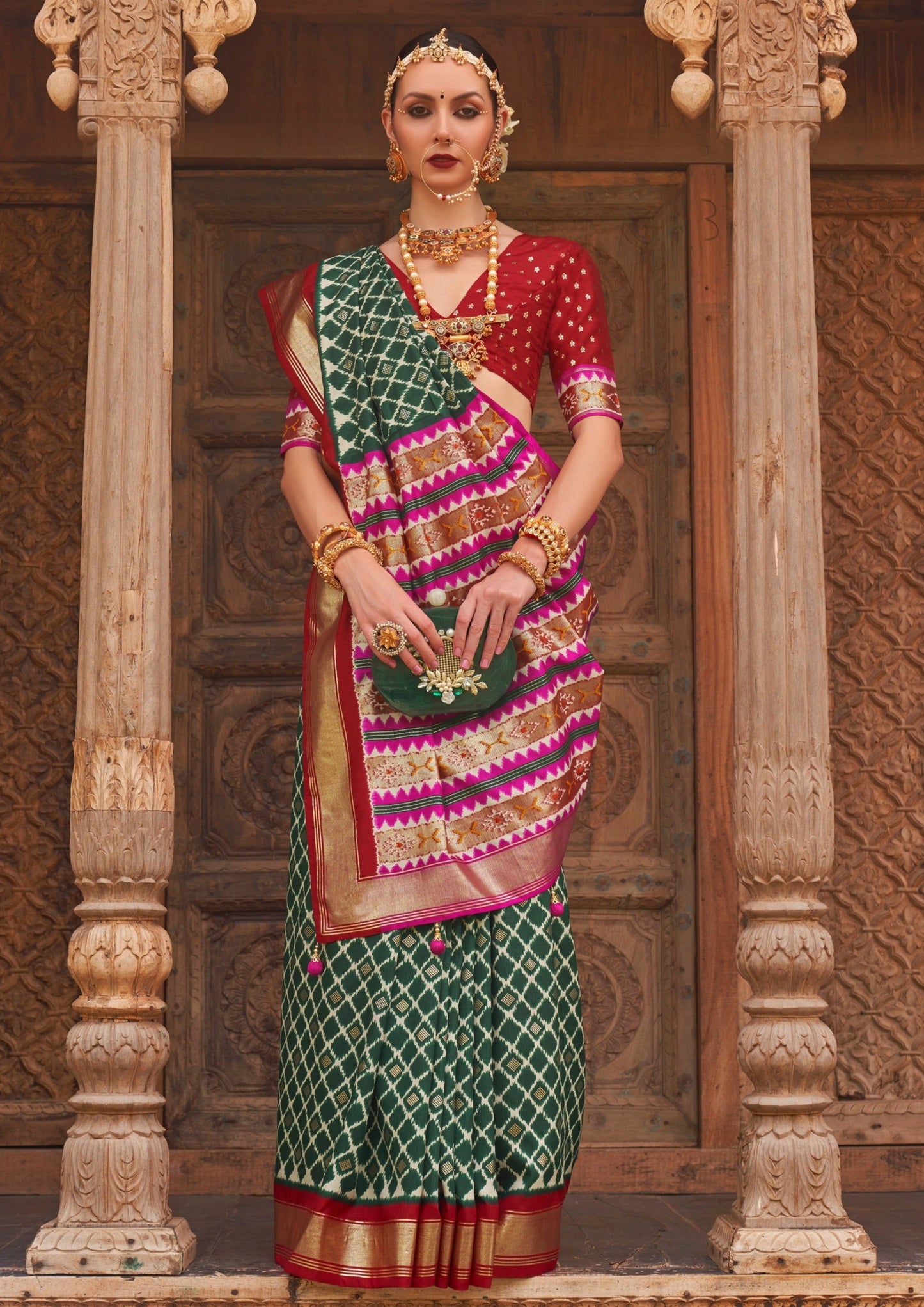 woman in green patola saree and red blouse