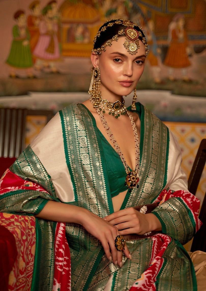 Designer patola silk saree in cream and green with handloom weaving for weddings in New York USA.